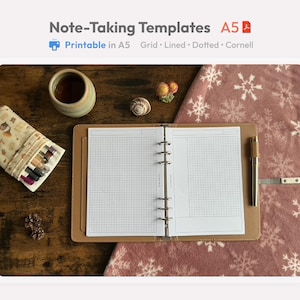 May include: An open A5 notebook with grid paper sits on a brown leather binder. A pen, a ceramic cup, and a pencil case are on a wooden surface. The text "Note-Taking Templates A5" is at the top.