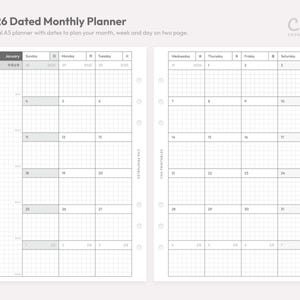 May include: A 2026 dated monthly planner layout on two pages with a grid pattern. The text reads 2026 Dated Monthly Planner, Cha Printables, and includes days of the week in English and Japanese. The white pages feature six binder holes.