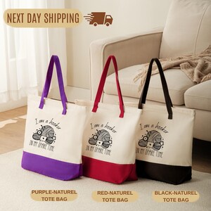 Three tote bags with different colors and designs, placed on a carpeted floor in front of a couch.