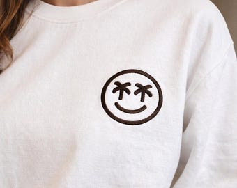 Moletom com estampa de palmeira sorridente | Logotipo bordado pequeno no peito