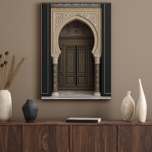 May include: A framed print featuring an ornate archway and doors with intricate gold and black geometric patterns. The arch is cream-colored with detailed carvings, set against a black border. The artwork hangs above a wooden cabinet.