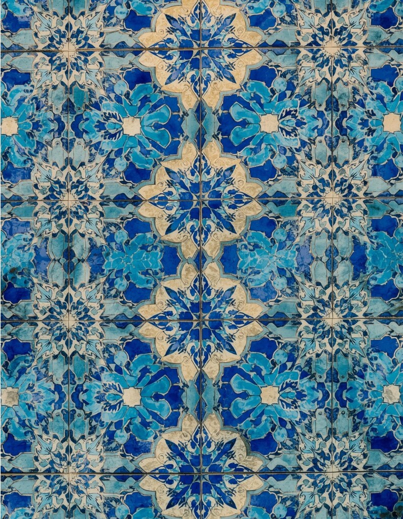 May include: A close-up of a tiled surface with a repeating pattern. The tiles feature a floral design in shades of blue and white. The pattern is symmetrical, with each tile contributing to the overall design. The tiles are arranged in a grid.