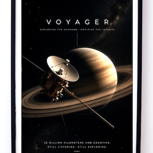 May include: A framed poster featuring the Voyager spacecraft in deep space with a large ringed planet in the background. The text reads VOYAGER, EXPLORING THE UNKNOWN. INSPIRING THE INFINITE, and 22 BILLION KILOMETRES AND COUNTING, STILL LISTENING. STILL EXPLORING.