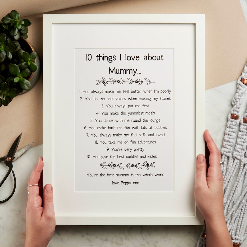 K&ouml;nnte beinhalten: Ein gerahmter Druck mit wei&szlig;em Hintergrund und schwarzem Text. Der Text lautet "10 Dinge, die ich an Mama liebe..." und listet 10 Gr&uuml;nde auf, warum jemand seine Mutter liebt. Der Druck ist mit "love Poppy xxx" signiert.