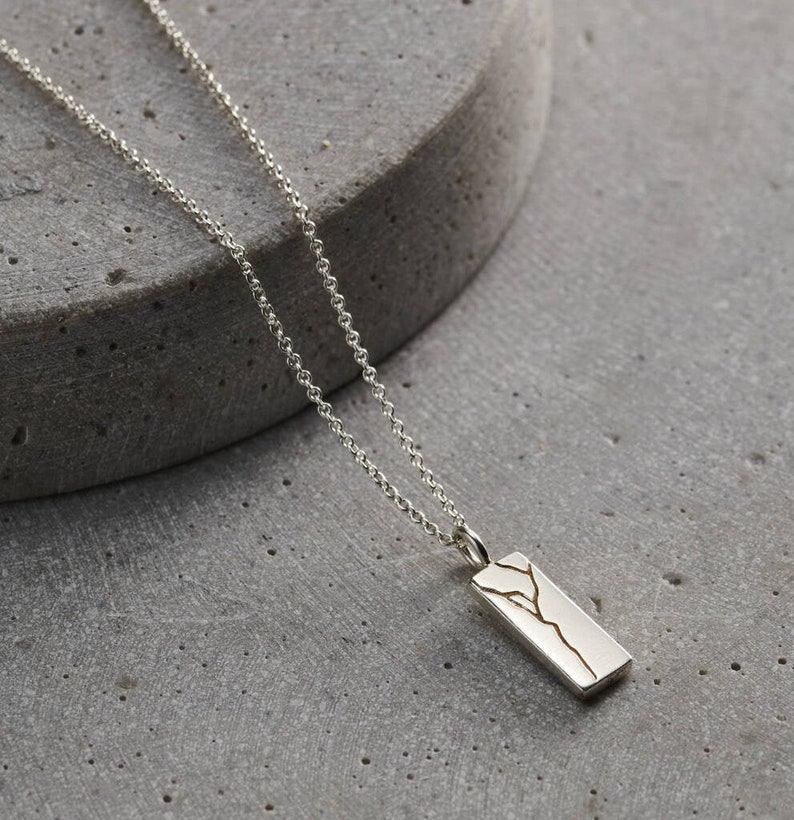 Men's Silver Tag Necklace with Kintsugi gold crack down the middle.