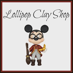 May include: A clay figurine of Mickey Mouse dressed as a wizard, wearing glasses and holding a broom and a golden object. The figurine is wearing a red jacket and gray pants. The text "Lollipop Clay Shop" is at the top.