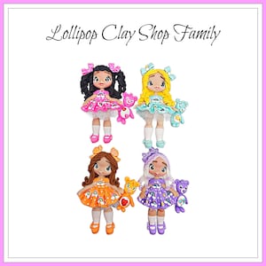 May include: Four handmade clay dolls with different hair colors and dresses. Each doll holds a small teddy bear. The dolls are wearing dresses in pink, blue, orange, and purple. The text "Lollipop Clay Shop Family" is at the top.
