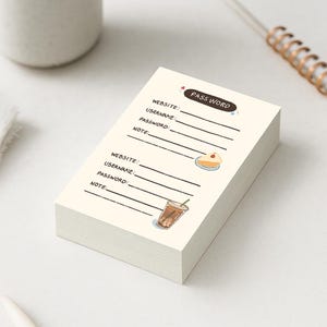 May include: A stack of cream-coloured password keeper notepads. Each page has lines for website, username, password, and notes. The top notepad has the words "PASS WORD" and illustrations of a cake and a drink.