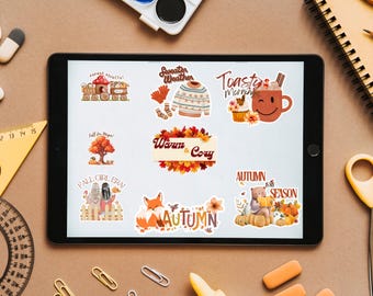 May include: A tablet displays colorful autumn-themed stickers. Designs include a train, sweater, mug, tree, fox, bear, and text that reads "Warm & Cozy", "Autumn is my Season", and "Fall Girl Era".