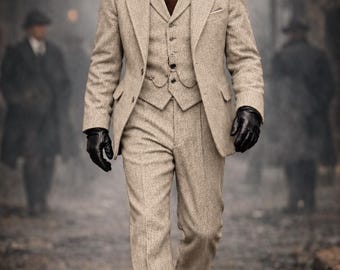 May include: A three-piece beige tweed suit comprising a blazer, a buttoned waistcoat with a pocket watch chain, and matching trousers. The ensemble is worn with a white collared shirt, a brown tie, a black flat cap, black leather gloves, and black boots.