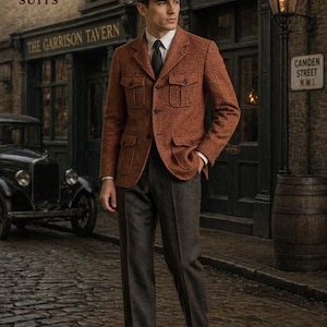 May include: A man in a rust-colored tweed jacket with four front pockets, paired with dark gray trousers and brown leather shoes. He wears a gray flat cap and a black tie. The background features a vintage car and a pub sign.