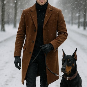 May include: A brown overcoat with a black turtleneck and black gloves. The person is walking a black and tan Doberman Pinscher on a leash in a snowy environment. The coat has a classic, tailored design.