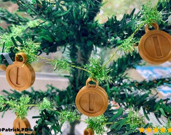 May include: Brown, circular Christmas ornaments with the number "1" in the center, hanging on a green Christmas tree. The ornaments have a loop at the top for hanging. The tree has green needles and is decorated with tinsel.