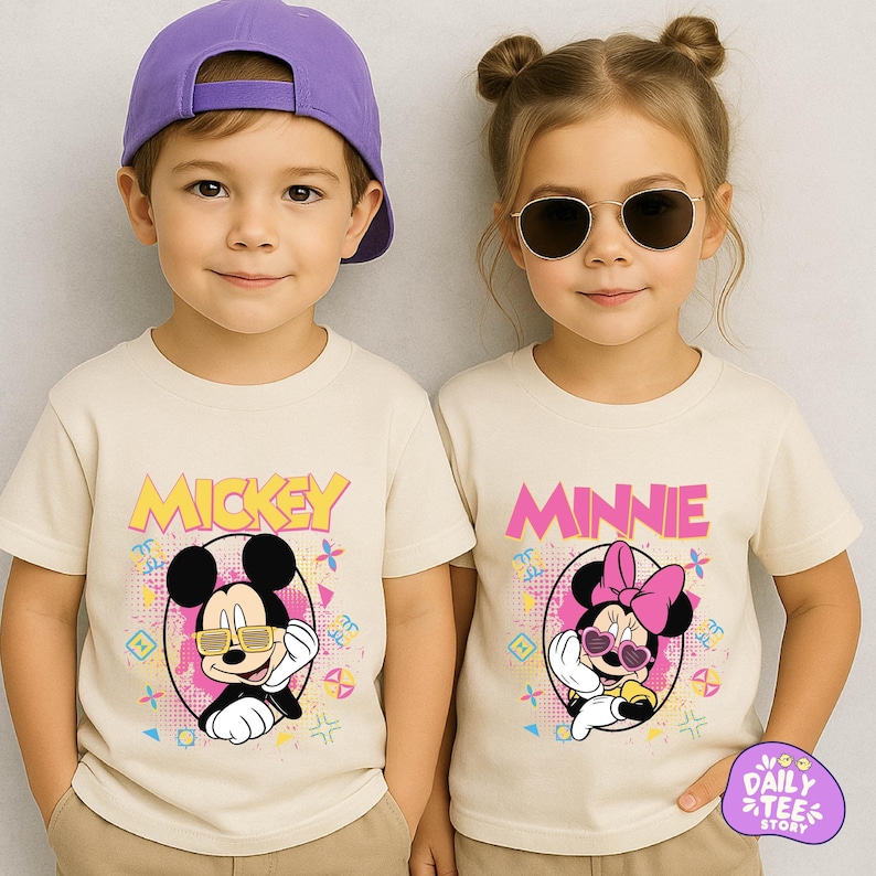 Two children wearing Mickey Mouse t-shirts and sunglasses, smiling at the camera.