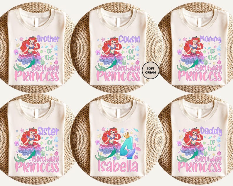 six white t-shirts with different designs and text related to birthday celebrations. The t-shirts feature a mermaid character and the names of the birthday person, such as "Brother of the Princess", "Cousin of the Birthday Princess", "Mommy of the Birthday Princess", "Sister of the Birthday Princess", "Daddy of the Birthday Princess", and "Isabella". The text on the t-shirts is colorful and includes the names of the birthday person and the character they are associated with.