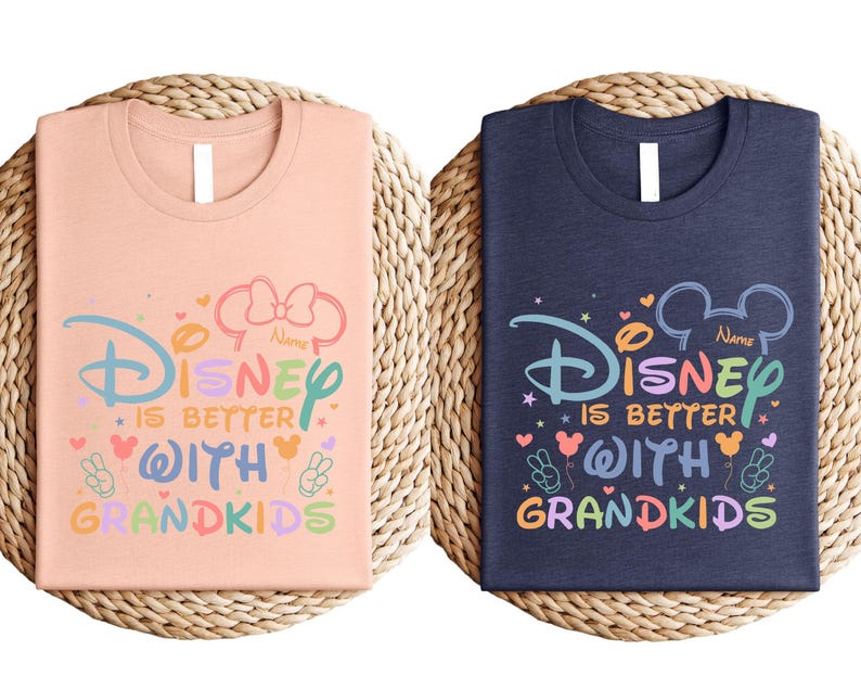 two Disney-themed t-shirts, one pink and one blue, with the text "Disney is better with Grandkids" printed on them.