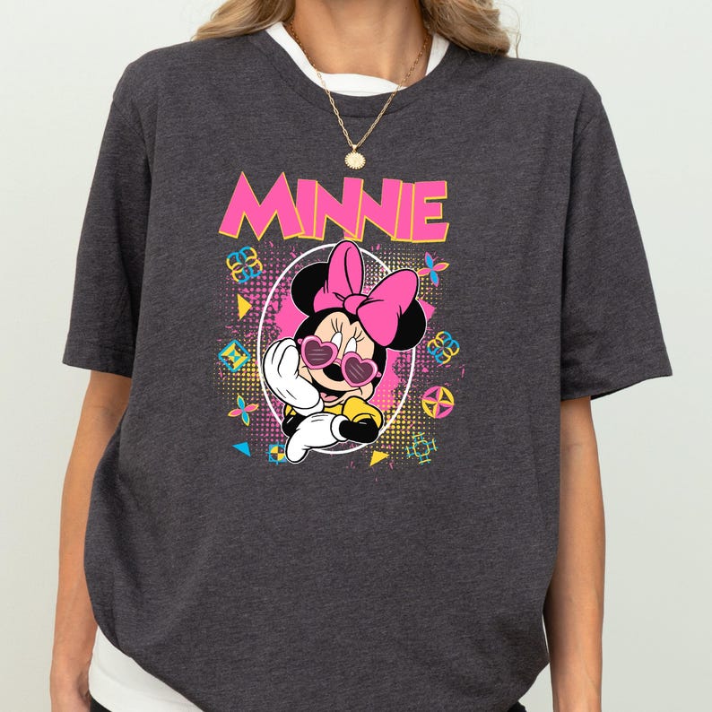a gray t-shirt with a graphic of Minnie Mouse wearing sunglasses and a bow.