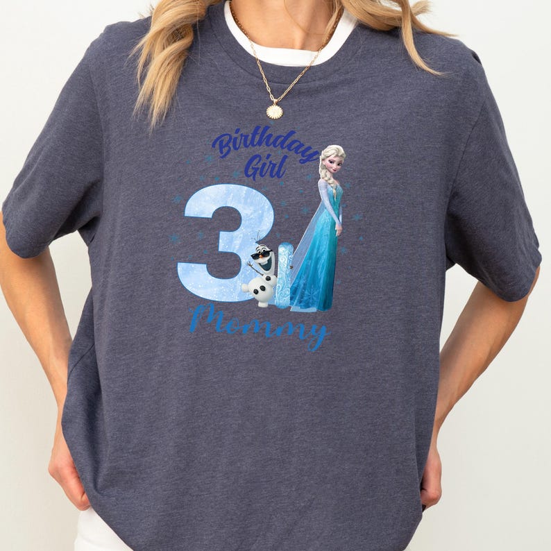 A gray t-shirt with a graphic design featuring a character from the Disney movie Frozen, along with the text "Birthday Girl 31 Mommy".