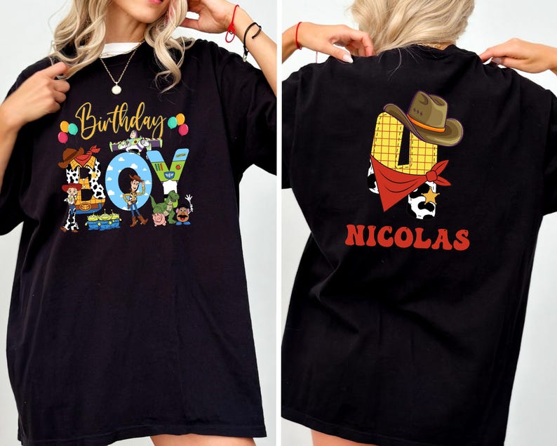 a person wearing a black t-shirt with a colorful graphic design on the front and a personalized name on the back.