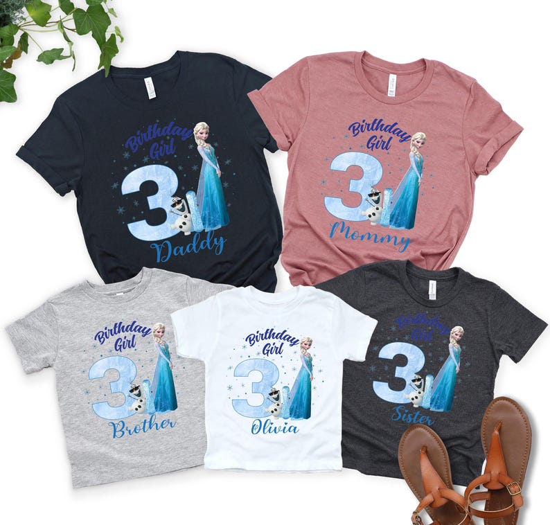 a collection of birthday t-shirts featuring a character from the Disney movie Frozen, specifically Elsa. The t-shirts are designed for different age groups, with the largest one for a 3-year-old and the smallest one for a 3-year-old sibling. The t-shirts are arranged in a row, showcasing the variety of sizes and designs.