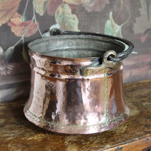 May include: A set of three ceramic mugs with a speckled, matte finish. The mugs are in shades of cream, light gray, and dark gray. Each mug has a simple, minimalist design and a rounded handle. The mugs are stacked on top of each other.