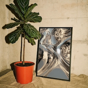 May include: A potted fiddle leaf fig plant with large green leaves in a bright orange plastic pot, positioned next to a rectangular framed print featuring a metallic, liquid-like abstract design with swirling silver and grey chrome reflections.