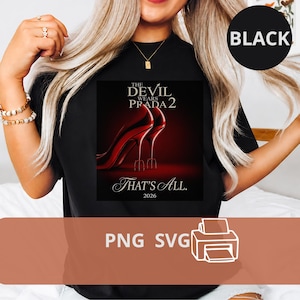 May include: Black t-shirt featuring a movie poster design for "The Devil Wears Prada 2." The poster shows red high heels and the text "That's All. 2026." A black circle with the word "BLACK" is in the upper right corner.