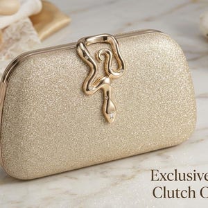 May include: A gold glitter clutch bag with a decorative clasp. The clutch is rectangular with rounded edges and a gold frame. The text "Exclusive Evening Clutch Collection" is at the bottom of the image.