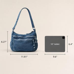 May include: A blue denim shoulder bag with multiple zippered compartments and a single strap. The bag measures 11.81 inches wide by 8.27 inches high. Next to it is a 10-inch tablet measuring 9.6 inches wide by 6.4 inches high for scale.