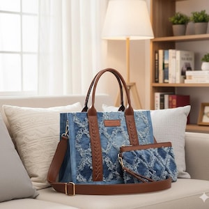 May include: A denim tote bag and matching clutch set with brown leather accents. The tote features a braided leather panel down the center and a detachable shoulder strap. The clutch has a wrist strap. Both pieces have a distressed denim design.