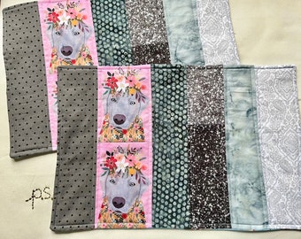 Gray Dog with Crown of Flowers and Floral Clothes vs Christmas Dogs Playing in the Snow Placemats - Reversible Dogs Quilted Placemat Pair