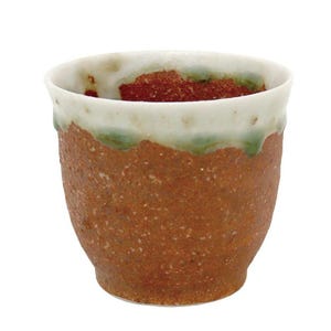 May include: A handmade ceramic cup with a textured, reddish-brown exterior. The rim is white with a green glaze detail. The interior has a reddish-brown color. The cup is designed for beverages.