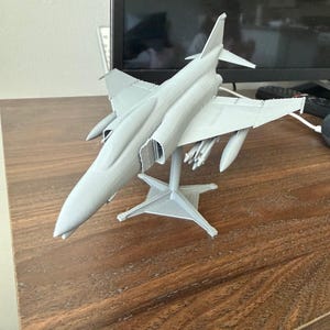 May include: A rustic wooden sign with the text "Welcome to our home" in white lettering. The sign features a distressed finish and a simple, inviting design, perfect for a front porch or entryway.