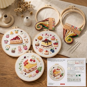 May include: Embroidery DIY art kit featuring three round hoops with embroidered dessert designs, including cakes and pastries. The kit includes embroidery floss, needles, and instructions. The hoops are made of wood.