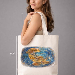 May include: A cream tote bag, 36.8 cm wide and tall, with a colourful map design. The map shows ancient continents and oceans, with labels such as Laurasia and Gondwana. The bag is being carried.