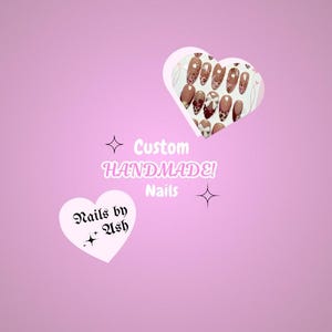 May include: A pink background with two white heart-shaped graphics. One heart contains a set of custom handmade nails. The other heart displays the text "Nails by Ash". The text "Custom Handmade! Nails" is also present.