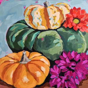 May include: An oil painting featuring a still life of pumpkins and flowers. The pumpkins are in shades of orange, green, and yellow, with a striped pumpkin on top. Bright red and magenta flowers add pops of color against a light blue background.