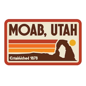 May include: A rectangular Moab, Utah sticker with a retro design. The sticker features the text "MOAB, UTAH" in brown, with a brown arch silhouette, and a yellow sun. The sticker also includes the text "Established 1878".