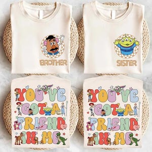 May include: Four cream-colored t-shirts with Toy Story character graphics. Two shirts have character portraits with "Brother" and "Sister" text. The other two shirts feature the phrase "You've Got a Friend in Me" with character illustrations.