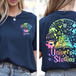 May include: A white ceramic mug with a black handle and the text "But First, Coffee" in a bold, black font. The mug is set against a blurred background, suggesting a cosy setting.