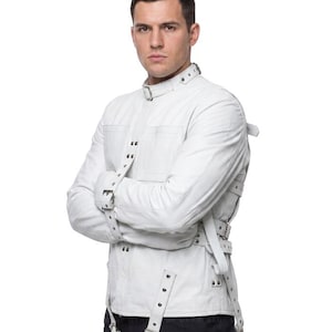 May include: White straight jacket with multiple straps and buckles. The jacket has a high collar and is worn over a dark shirt. The image has the text "BLUE GEAR" at the bottom.