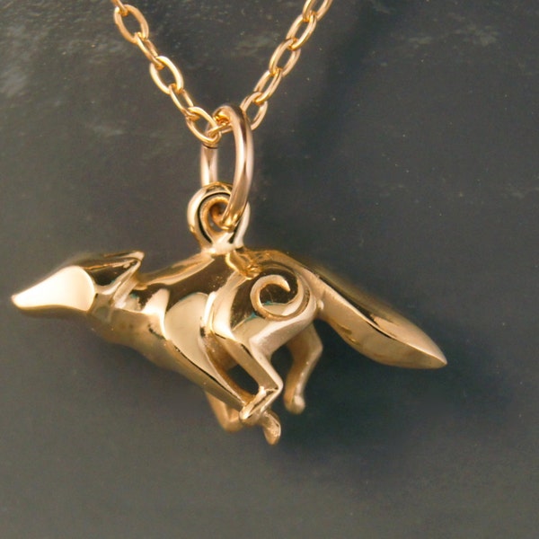 coyote. running,  bronze necklace
