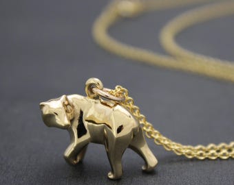 grizzly charm , bronze