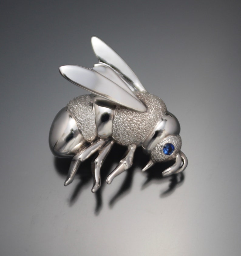 silver bee pin / pendant with blue sapphire eye image 1