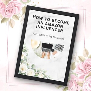 May include: A framed print with the text "HOW TO BECOME AN AMAZON INFLUENCER" and "With Little To No Followers." The image inside the frame shows a laptop, a hat, and other accessories. The frame is black, and the background has floral decorations.