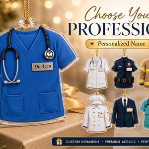 May include: A blue V-neck scrub top ornament with a black stethoscope and a name tag reading Dr. Ryan. The image displays various profession-themed acrylic ornaments including a white lab coat, police uniform, firefighter gear, chef coat, suit, and teal scrubs.