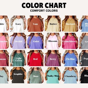 May include: A color chart displaying a variety of Comfort Colors t-shirts. The chart includes colors such as white, ivory, yam, butter, mustard, blue jean, watermelon, orchid, violet, blossom, crunchberry, grey, crimson, light green, red, berry, flo blue, pepper, bay, graphite, moss, chalky mint, chambray, and black.