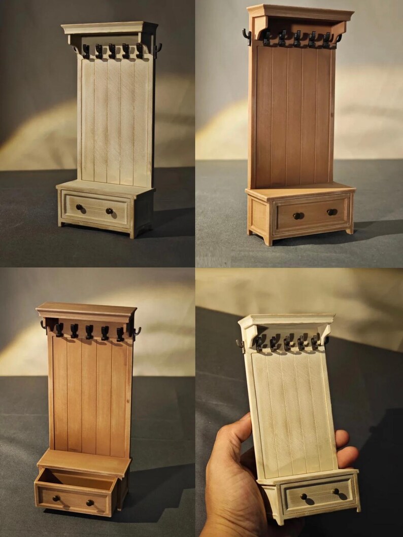 May include: A miniature wooden hall tree with a bench, drawer, and coat hooks. The light-colored wood has a vertical plank design on the back panel. The bench has a drawer with two round knobs. The coat hooks are black.