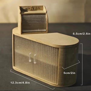 May include: A miniature wooden cabinet with a light brown finish. The cabinet has a curved design with a textured, semi-transparent front. It measures 4.8 inches wide, 2 inches deep, and 2.6 inches tall. A smaller, matching top piece is attached.