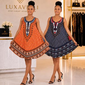 May include: Two sleeveless A-line dresses featuring intricate geometric patterns and a central decorative neckline design. One dress is orange with blue and white accents, while the other is navy blue with white and red accents, both with hem borders.